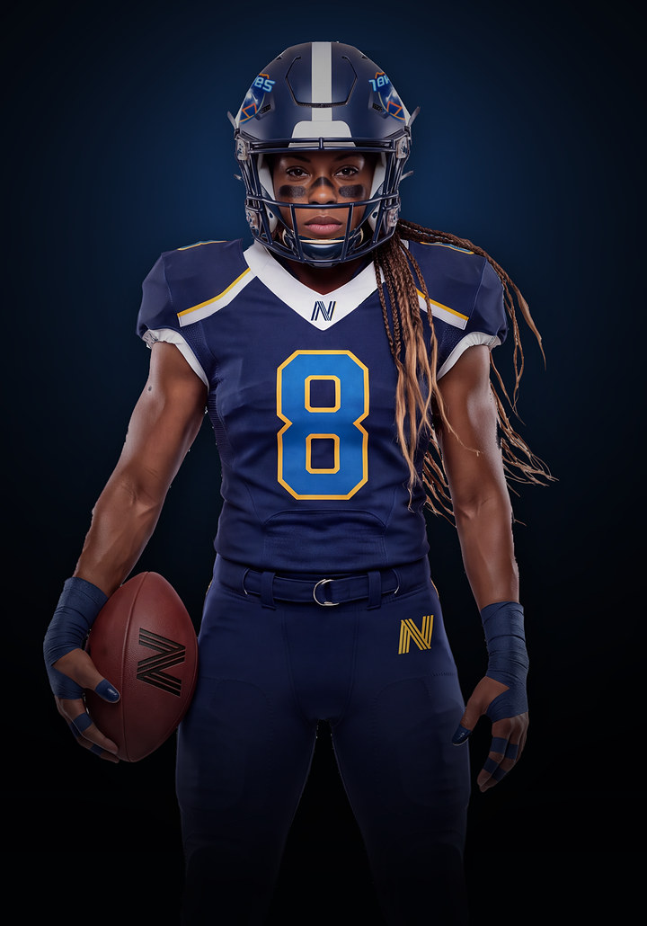 Colorado 14ers athlete in a navy number 8 jersey, holding a football